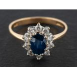 A 9ct gold, sapphire and round, brilliant-cut diamond cluster ring, estimated sapphire weight ca. 1.