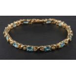 An oval, mixed-cut aquamarine and single-cut diamond 'X'-link bracelet,