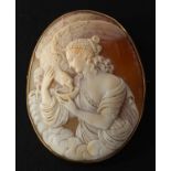 A carved shell cameo brooch depicting Hebe, the goddess of youth, the mount stamped '9CT', length 5.