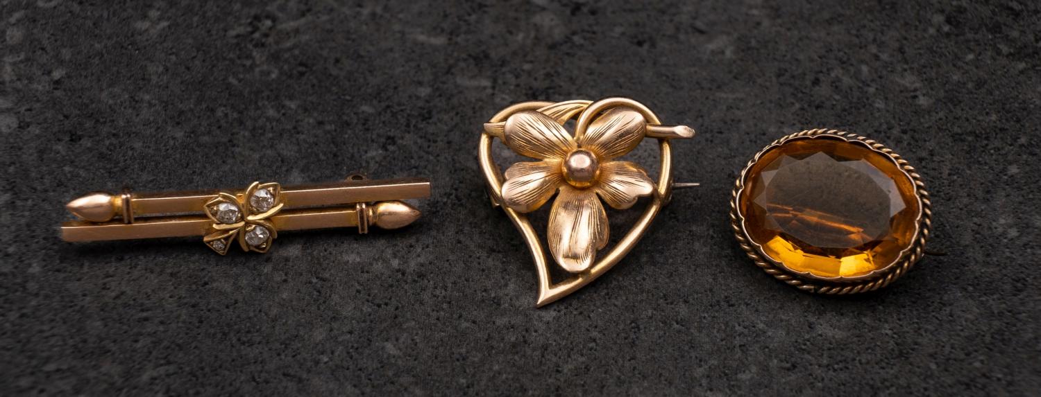 Three brooches, including an oval mixed-cut citrine brooch, estimated citrine weight ca.