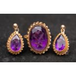 A 9ct gold, oval, mixed-cut amethyst ring and pair of drop earrings, with ropework surround,