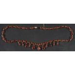 A late Georgian, 9ct gold, flat-cut, foiled-back, collet-set, garnet fringe necklace,