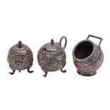 An Indian silver three-piece condiment set with foliate and scroll decoration, 154gms, 4.95ozs.