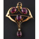 An oval, mixed-cut garnet and seed pearl, openwork brooch/ pendant, length ca. 4.