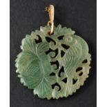 A circular, carved jade pendant, depicting pheasant and foliage, diameter ca. 3.