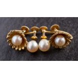 Two pairs of cultured pearl ear clips, including a 9ct gold pair of flowerhead design,