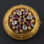 An Etruscan Revival garnet and probably quartz locket pendant/ brooch,