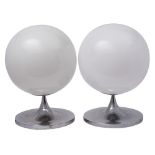 A pair of 1970's style globe shaped table lamps with opaque glass shades on chrome stems with