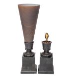 A pair of bronze table lamps, of urn-shaped outline: with trumpet-shaped flared shade,