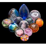 A collection of glass paperweights including examples by Mdina, Whitefriars and The Glass Eye,