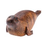 Almost certainly Jeff Soan, (British, contemporary), an articulated beechwood model of a seal,