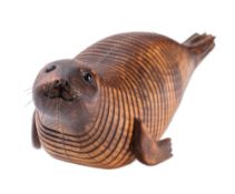 Almost certainly Jeff Soan, (British, contemporary), an articulated beechwood model of a seal,