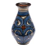 A Darico Pottery 'Skønvirke' vase of baluster form with slip trailed scrolling decoration in blue,