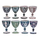 Aldermaston Pottery a group of eight terracotta goblets each with brushwork decoration,