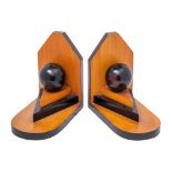 A pair of Art Deco period wood and ebonised book ends with circular globe raised on triangular