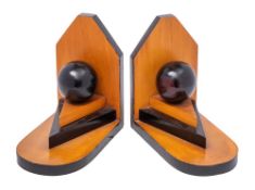 A pair of Art Deco period wood and ebonised book ends with circular globe raised on triangular