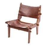 An Ecuadorian teak and maroon leather covered lounge chair, by Angel Pazmino,