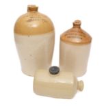 Two Honey top spirit jars and a hot water bottle, the largest stamped 'Wright & Son, Grocers,
