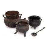 An iron twin-handled cauldron: of traditional bag shape, 27cm across,