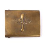 A German belt buckle, brass with winged swastika over a vertical propeller.