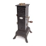 A 19th Century French clockwork spit engine in blackened tin and metal casing,