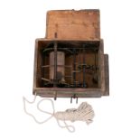 A 19th Century mechanical hoist contained in a wooden box with cover,