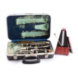 A Bousey & Hawkes 'Regent' clarinet in case, together with a Wittner metronome.