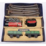 A Hornby O gauge post-war MO Goods Set: 0-4-0 loco and tender in red with two green wagons and