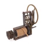 A French steel and brass spit jack with triple brass wheels gripping the rope driven pulley.