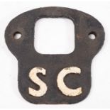 A cast iron locomotive 'SC' (self cleaning) plate.