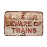 A L&SWR cast iron 'Beware of Trains' notice, 42 x 66cm.