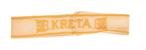A German 'Kreta' cuff title, gold embroidery on a khaki band.