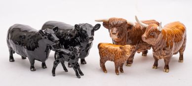 A group of Beswick cattle comprising an Aberdeen Angus cow,