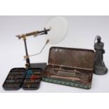 A collection of various fly fishing equipment including a fly tying stand, lines, fly cases,