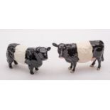 A group of Beswick cattle comprising a Belted Galloway bull and a Belted Galloway cow,