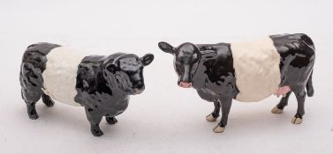 A group of Beswick cattle comprising a Belted Galloway bull and a Belted Galloway cow,