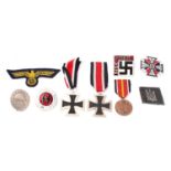 A small collection of reproduction German military medals and badges.