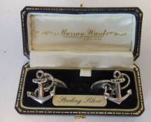 A pair of silver cuff links, stamped marks, in the form of fouled anchors, cased.