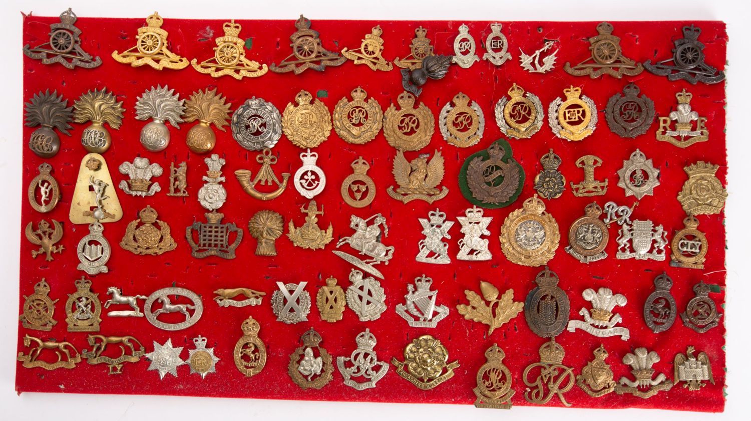 A collection of British Regimental cap badges including two City of London Rough Riders 1905-08