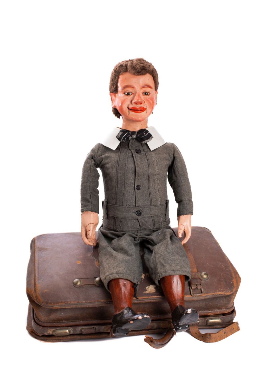 A late 19th/early 20th century ventriloquial 'dummy' figure of a young boy: the painted mache head