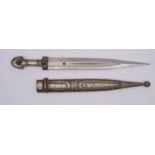 A white-metal mounted jambiya, the straight double edge blade with fuller,