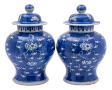 A pair of Chinese blue and white baluster jars and covers,