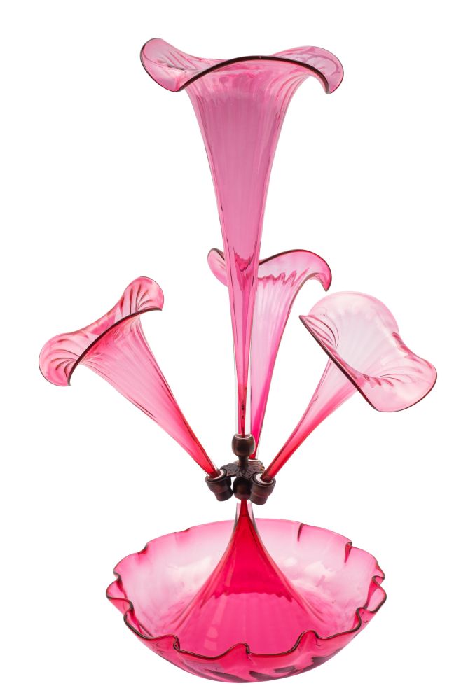A cranberry glass epergne with central trumpet shape vase flanked by three smaller set on a shallow