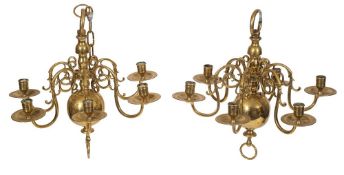A very near pair of Dutch brass six light chandeliers,
