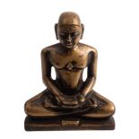 A Jain bronze figure of Suparsvanatha seated in the lotus position,