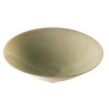 A Chinese celadon glazed bowl, probably Song and of thinly potted form on a shallow foot,