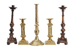 A pair of Continental, probably Italian, carved and stained walnut altar candlesticks,