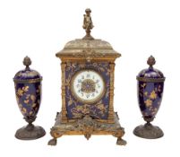A late-Victorian brass and porcelain mantel clock garniture the eight-day duration movement
