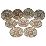 A matched set of nine Canton dishes, Qing Dynasty, 20-21cm [one with minor hair crack].