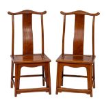 A pair of Chinese stained hardwood yoke back side chairs, in 17th century style,